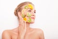Smiling woman with fruit mask on her face isolated Royalty Free Stock Photo