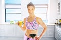 Smiling woman with glass of orange fresh