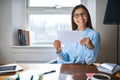 Smiling woman in glasses holding envelope