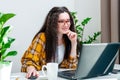 Smiling woman in glasses typing on laptop keyboard is working at home, writing emails, online shopping or watching video Royalty Free Stock Photo