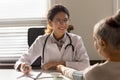 Woman doctor measure blood pressure of old female patient