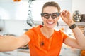 Smiling woman in Halloween decorated kitchen taking selfie Royalty Free Stock Photo