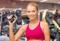 Smiling woman with hand expander exercising in gym Royalty Free Stock Photo