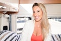 Smiling woman happy in vanlife campervan interior in Camper Van RV motor home concept of vacation Royalty Free Stock Photo