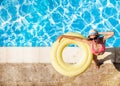 Smiling woman in hat with rubber ring by the pool Royalty Free Stock Photo