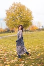 Smiling woman having fun in autumn park outdoors. Real people Royalty Free Stock Photo