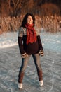 Happy woman enjoying ice skating on a frozen lake Royalty Free Stock Photo