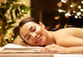 Smiling woman having hot stone massage at spa Royalty Free Stock Photo