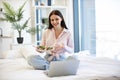 Smiling woman having video chat on wireless laptop while eating healthy salad. Royalty Free Stock Photo