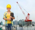 Smiling woman in helmet with clipboard Royalty Free Stock Photo