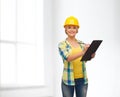 Smiling woman in helmet with clipboard Royalty Free Stock Photo