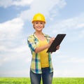 Smiling woman in helmet with clipboard Royalty Free Stock Photo