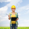 Smiling woman in helmet with clipboard Royalty Free Stock Photo