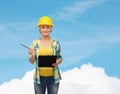 Smiling woman in helmet with clipboard Royalty Free Stock Photo