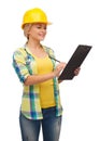 Smiling woman in helmet with clipboard Royalty Free Stock Photo