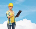 Smiling woman in helmet with clipboard Royalty Free Stock Photo
