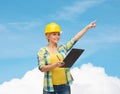 Smiling woman in helmet with clipboard Royalty Free Stock Photo