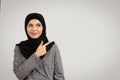 Smiling woman in hijab pointing to empty space Royalty Free Stock Photo