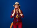 Smiling woman hiker shouting through megaphone shaped hands Royalty Free Stock Photo