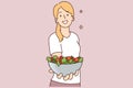 Smiling woman hold bowl of vegetarian salad