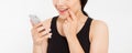 Smiling woman hold cellphone. Closeup young happy beautiful asian japanese woman. Girl looking at mobile cellphone isolated on whi Royalty Free Stock Photo