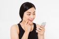 Smiling woman hold cellphone. Closeup young happy beautiful asian japanese woman. Girl looking at mobile cellphone isolated on whi Royalty Free Stock Photo