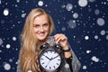 Smiling woman holding alarm clock Royalty Free Stock Photo