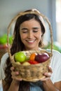 Smiling woman holding a basket of fruits Royalty Free Stock Photo