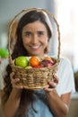 Smiling woman holding a basket of fruits Royalty Free Stock Photo