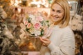 Smiling woman holding beautiful delicate pink bouquet of fresh peony roses in her hand Royalty Free Stock Photo