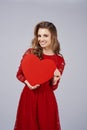 Smiling woman holding a big, red heart Royalty Free Stock Photo