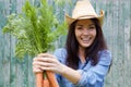 Smiling woman holding bunch of carrots Royalty Free Stock Photo