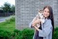 Smiling woman holding cute husky puppy