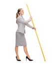 Smiling woman holding flagpole with imaginary flag Royalty Free Stock Photo
