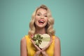 Young smiling woman holding gift. Valentine day.