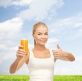 Smiling woman holding glass of orange juice Royalty Free Stock Photo