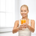 Smiling woman holding glass of orange juice Royalty Free Stock Photo