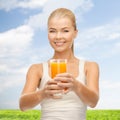 Smiling woman holding glass of orange juice Royalty Free Stock Photo