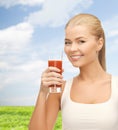 Smiling woman holding glass of tomato juice Royalty Free Stock Photo