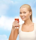 Smiling woman holding glass of tomato juice Royalty Free Stock Photo