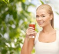 Smiling woman holding glass of tomato juice Royalty Free Stock Photo