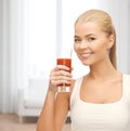 Smiling woman holding glass of tomato juice Royalty Free Stock Photo