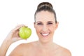 Smiling woman holding green apple looking at camera Royalty Free Stock Photo