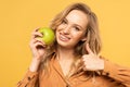 Smiling woman holding green apple and Royalty Free Stock Photo