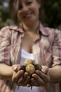 A smiling woman holding handful of potatoes Royalty Free Stock Photo