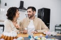 Smiling woman holding paintbrush near husband Royalty Free Stock Photo