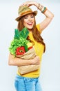 Smiling woman holding paper bag with green vegan food