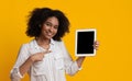 Smiling Woman Holding And Pointing At Digital Tablet With Black Screen Royalty Free Stock Photo