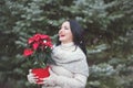Smiling Woman Holding Pot With Christmas Red Poinsettia Plant Royalty Free Stock Photo