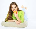 Smiling woman holding red apple lying on a floor with crossed l Royalty Free Stock Photo